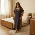 Woman wearing a melanzane (deep purple) and lizard belly green spray pattern big size nighty with contrast neckline, half sleeves, relaxed fit, and full-length comfortable home wear available in  XXXL.
